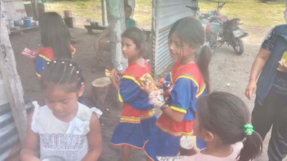 Children in traditional dress with snacks